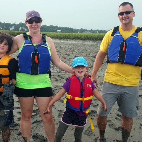 A family posing near a salt marsh in Myrtle Beach, SC