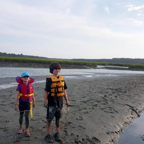 Two children exploring a beach before kayaking in Myrtle Beach, SC
